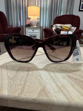 Kurt Geiger London women's dark brown tortoise shell cat eye sunglasses.
